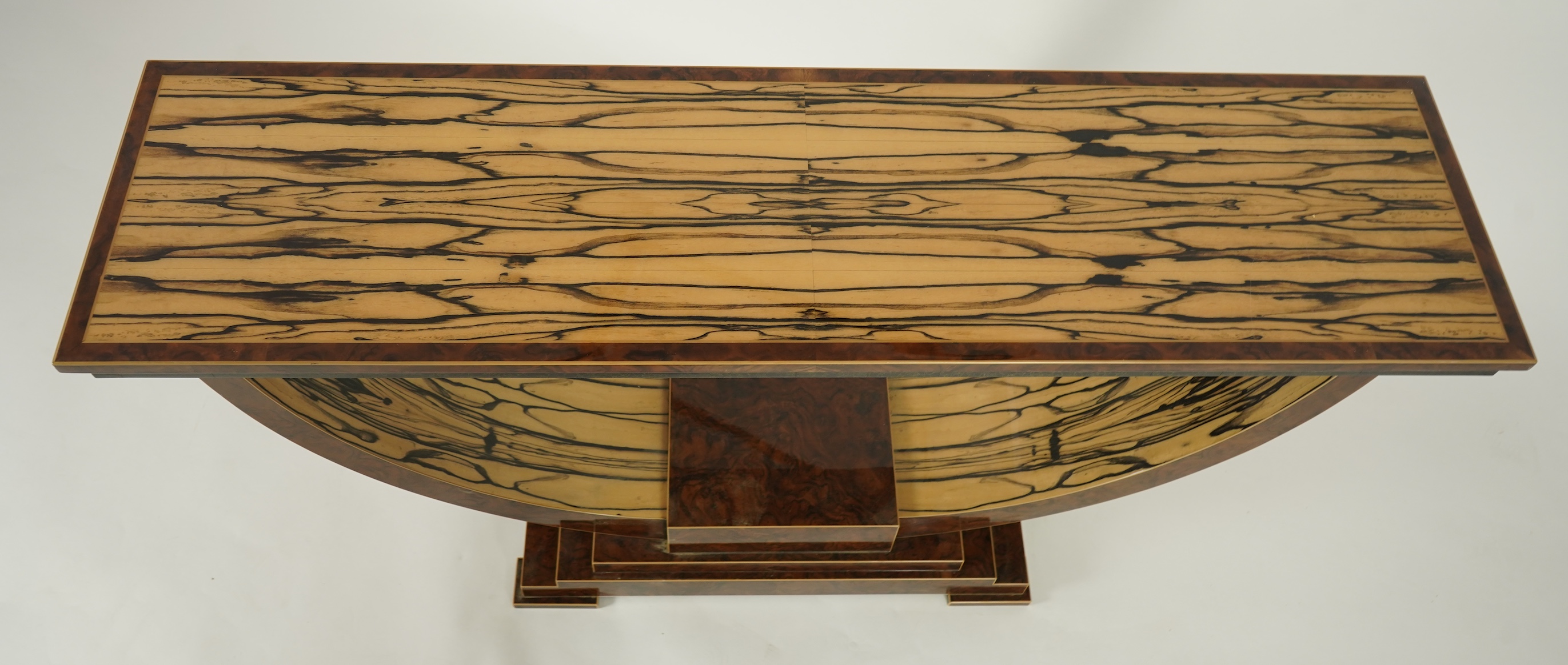 An Art Deco style white ebony and walnut console table